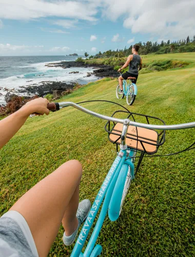 Couple biking along the coast of a resort near Hāna on Maui in Hawaiʻi