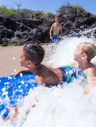 Two boys and their father at a beach on the Kohala Coast of the island of Hawaiʻi