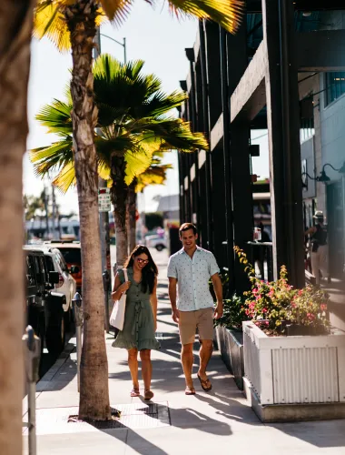 People walk through an outdoor shopping center
