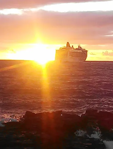 Sun set behind a cruise ship in the ocean