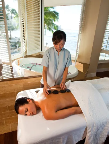 Warm stone massage at a resort on Oʻahu in Hawaiʻi