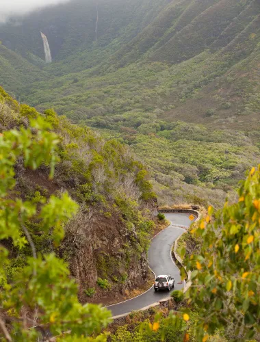 Car on a scenic road in Hālawa Park on Moloka‘i in Hawaiʻi