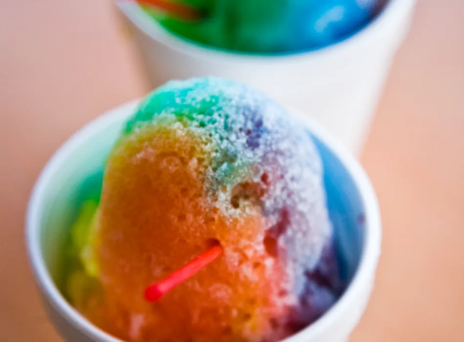 Two cups of colorful shaved ice.